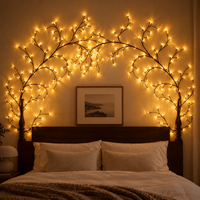Willowglow Tree Branch Glow arched above a bed headboard